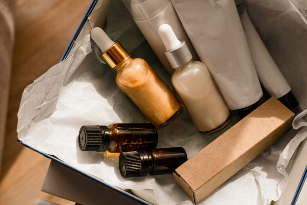 Flat lay of a beauty box with oil-based skincare bottles – visual representation of starting your own skincare brand