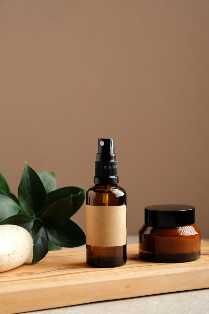 Natural skincare product bottles on a wooden tray – visual representation of a clean and honest brand identity. how to start a skincare business
