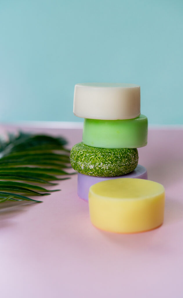 Stacked solid shampoo bars with natural colors – eco-friendly, waterless haircare concept.